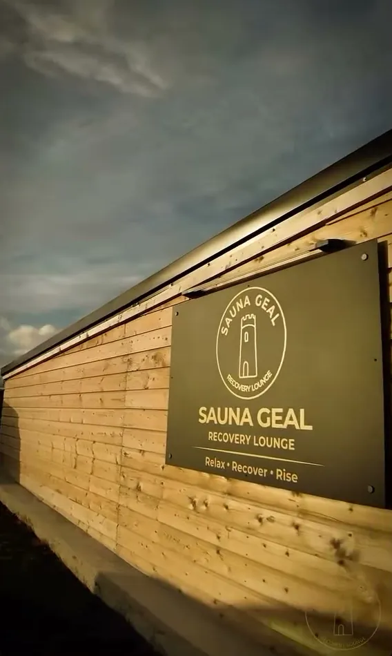 The timber-clad outside of the lounge with the Sauna Geal sign