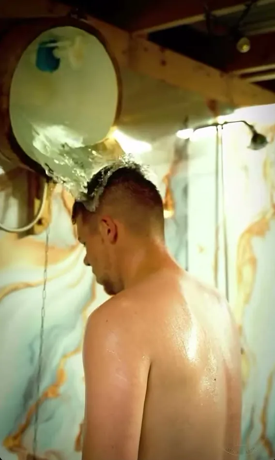 Cold water tipping from an overhead bucket shower
